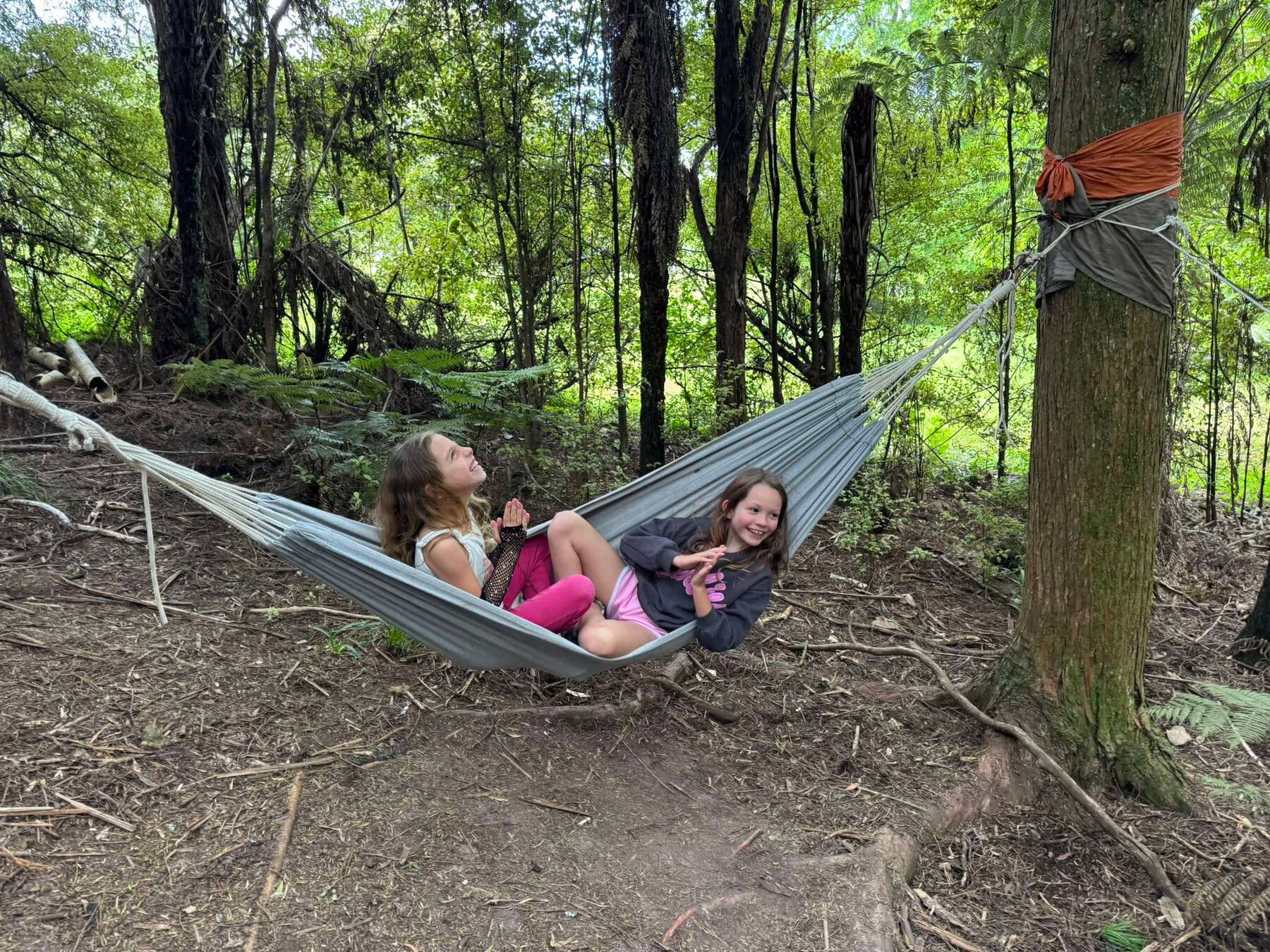 Children relaxing together in the forest