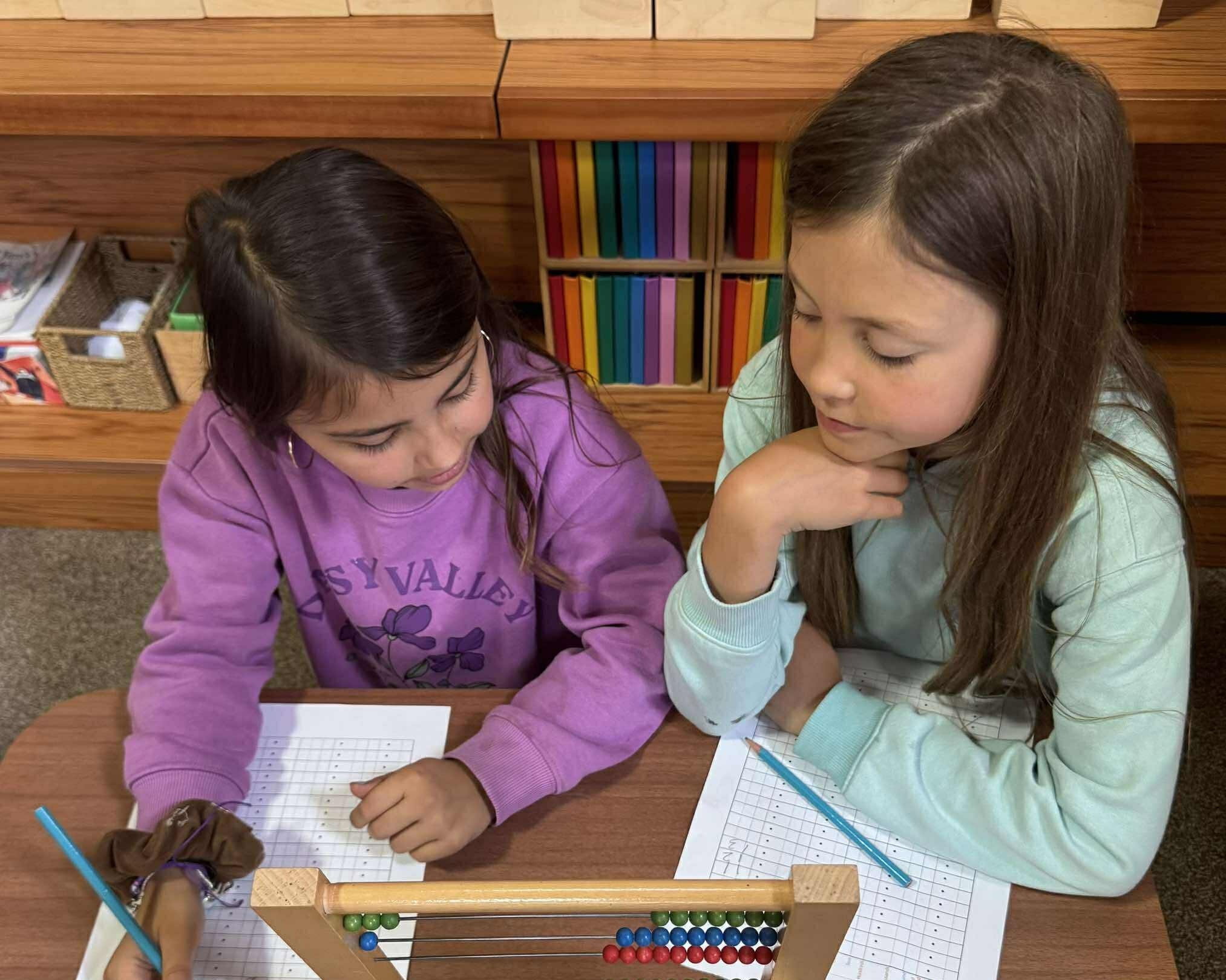 Children working with Montessori abacus materials